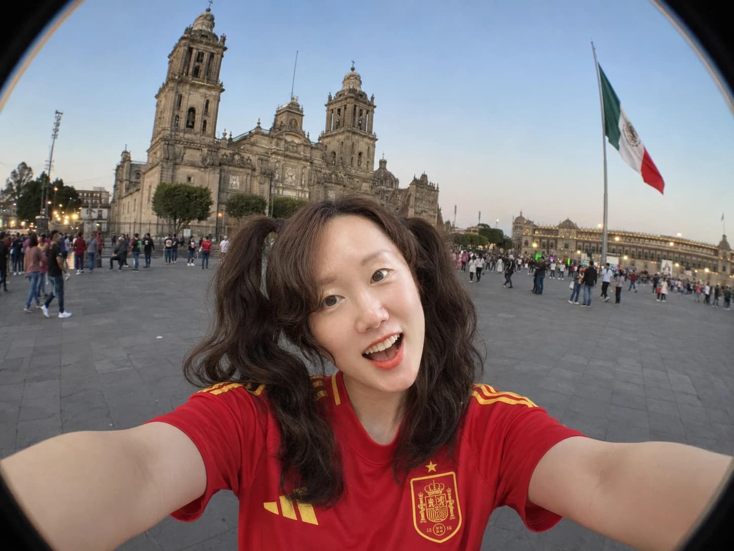 Traveler selfie in Mexico City Zocalo with Metropolitan Cathedral at dusk